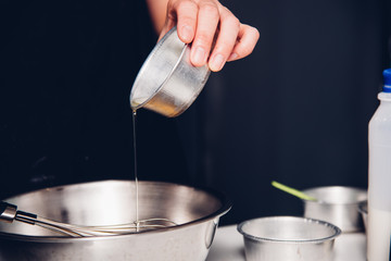 Woman during making pouring oil