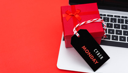 Online shopping, Promotion Cyber Monday Sale text on black tag with computer laptop and gift box