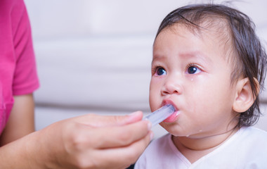Asian Baby sick he take medicine by syringe with copy space, medical care