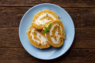 Pumpkin Roll with powdered sugar with walnuts and pumpkin seeds. Top View.