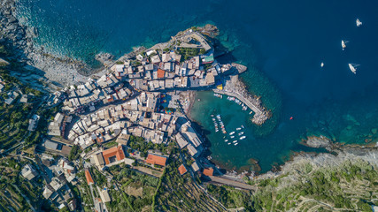 Overhead aerial view of Vernazza port beach in Cinque Terre, Italy during noon time