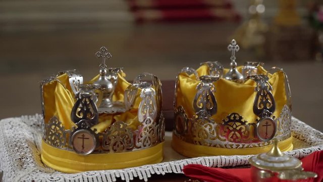 Wedding crowns. The wedding in the Church. Marriage ceremony in a Christian Church. The priest, the bride and groom inside