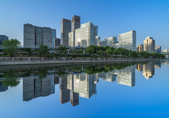 Business district office buildings and water reflection in Beijing .