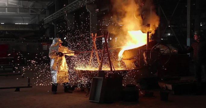 Hard work in the foundry. Pouring molten steel. Liquid steel pouring. Molten metal pouring, metallurgy, steel casting foundry. Steel manufacturing