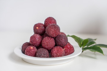 Sweet and sour red fruit bayberry, before a white color background