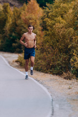 trail running athlete exercising for fitness and health outdoors on mountain pathway