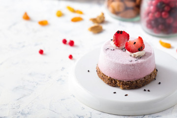 Vegan strawberry dessert. Raw cake with nuts, berries, fruits and seeds. Healthy food