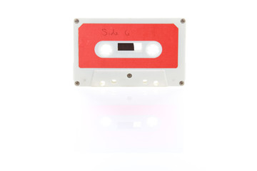 Audio cassette tape with reflection on a white background
