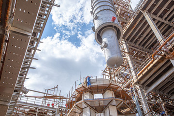 MOSCOW, RUSSIA, 08.2018: Construction of an oil refinery near Moscow. Workers install components of an oil refinery, construction and installation of components of an oil refinery in the suburbs.