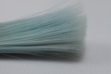 Close up picture of a brush with blue hairs