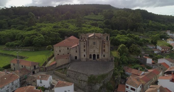 Aerial: Drone panning over Convento del carmen amidst buildings against trees in town - Padron, Spain