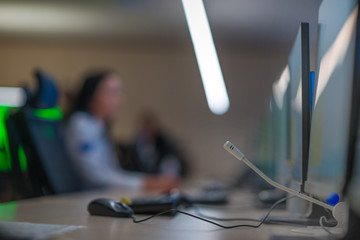 Security guard monitoring modern CCTV cameras in a surveillance room.