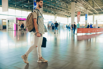 Cute adult male is waiting for plane