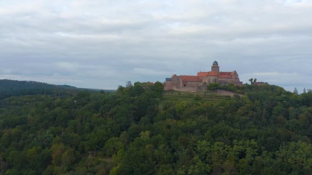 Aerial view of the castle Burg Breuberg in Germany. On a cloudy day in autumn. Zoom in on the castle.