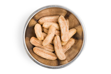 Ripe bananas that are sun-dried for preservation, placed in an aluminum bowl on isolated white background with clipping path.