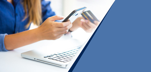 online shopping concepts. Woman hand  holding mobile phone and credit card with Payment Detail page display. using smartphone and laptop computer for online shopping