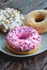 Sweet colorful dessert. Donut with a hole and pink delicious icing.