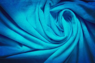 Interesting clothing background. Blue texture of wrinkled material.