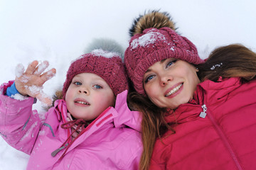 Fashionable stylish family having fun playing in snow. Weekends activities outdoor in cold weather. Winter fun family. Happiness to be parent. Family look. Lifestyle concept. Atmospheric moment.