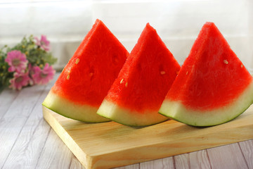 slices of red watermelon on cutting board