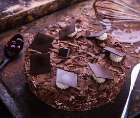 Black forest cake filled with cherries on a rustic surface