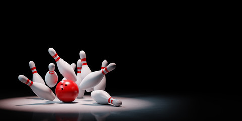 Bowling Strike of Skittles Spotlighted on Black Background