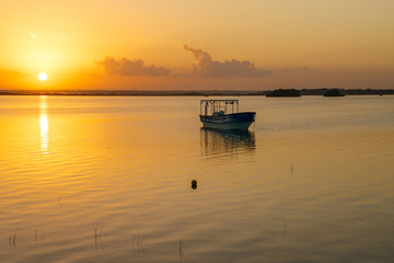 Fototapeta na wymiar Sunrise above quiet water of Bacalar lagoon in Mexico