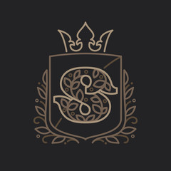 S letter logo consisting of floral pattern letters in a heraldic shield with crown.