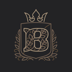 B letter logo consisting of floral pattern letters in a heraldic shield with crown.