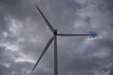 wind turbine against cloudy sky