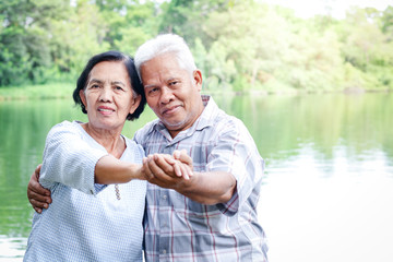 Elderly lovers holding hands dancing in the garden Have fun in retirement life. Senior community concepts