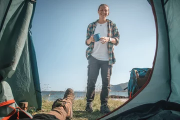 Crédence de cuisine en verre imprimé Reinefjorden View from the tourist tent to happy girl on the beach, adventure wild camping in Norway