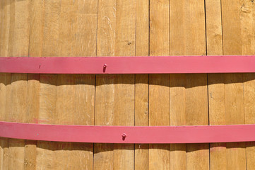 Close up of wooden wine barrel with red metal bands