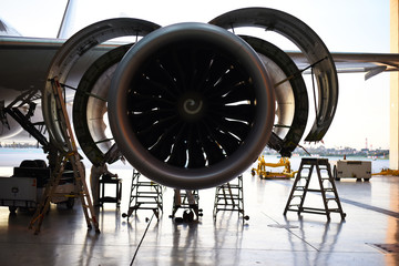 Open jet engine on a widebody commercial airplane. © Martin
