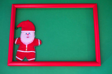 Santa Claus stands in a red frame