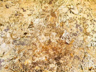Gold leaf texture on Buddha statue in temple