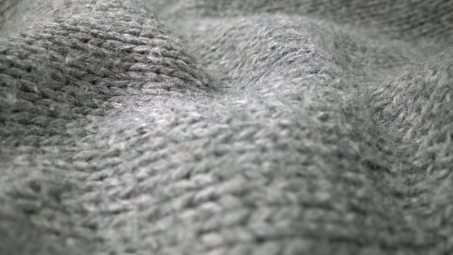 Extreme detail view of sheep wool cloth texture in macro dolly shot. Flowing animal fiber material for handcraft knitting. Textile abstract background. Winter fashion clothing industry concept.