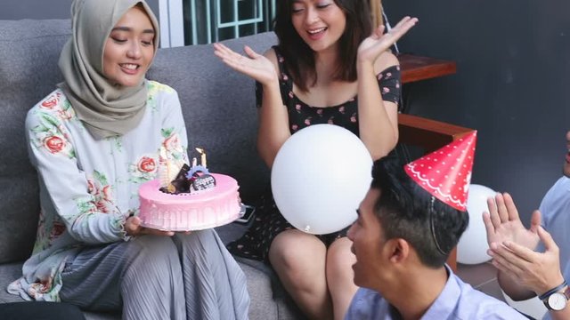 Group of friends enjoying brithday party and singing together