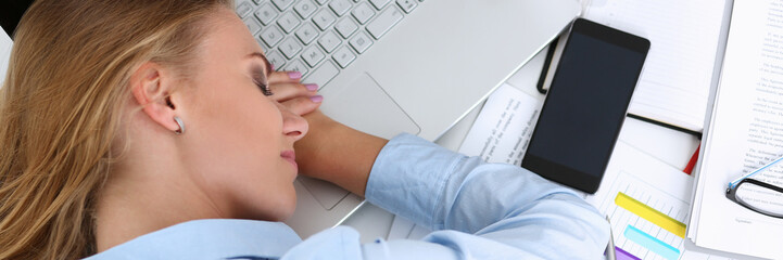 Tired businesswoman at workspace in office