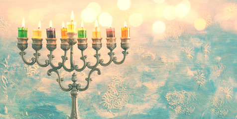 Religion image of jewish holiday Hanukkah background with menorah (traditional candelabra) and oil candles