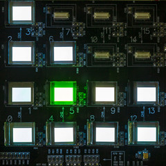 The process of checking several oled displays on the test station. Displays glow brightly of green...