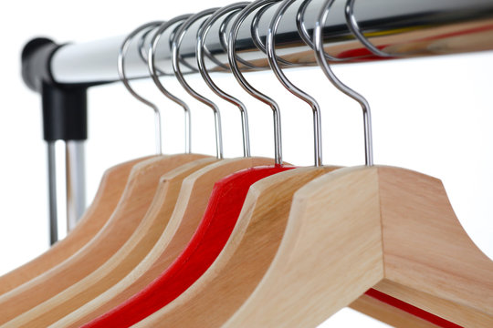 Red and wooden hanger hanging on metal