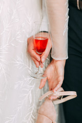 Intimate parts of the body, the atmosphere of the occasion. Wedding shoes, dress details and hands.
