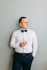  Wedding in European style. Stylish modern groom in the interior Studio.