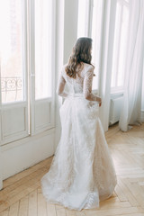 Beautiful girl in white dress, European wedding. Air and light photo shoot of the bride.