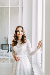 Beautiful girl in white dress, European wedding. Air and light photo shoot of the bride.