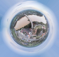 Aerial view above the bridge crossing Mae Klong river with cloudy sky background, Ban Pong, Ratchaburi, Thailand. (Pola graphic round earth concept)
