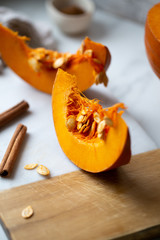 pumpkins with cinnamon sticks on marble backgrund