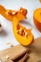pumpkins with cinnamon sticks on marble backgrund