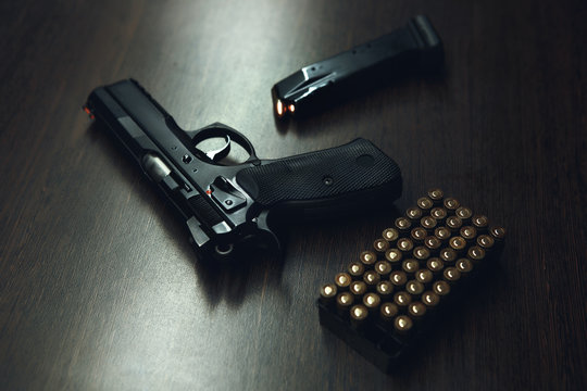 Close-up of a 9mm pistol and ammunition